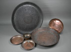 A large Middle-Eastern engraved and embossed copper charger, 52 cm diameter, four various 19th