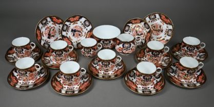 A Royal Crown Derby Imari tea service comprising tea cups and saucers, twelve plates and a milk