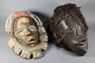A West African Dan tribe mask, Deangle, Ivory Coast or Liberia, the carved oval stained hardwood