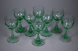 A set of eight green cut wine-glasses with hollow baluster stems and ground-out pontils