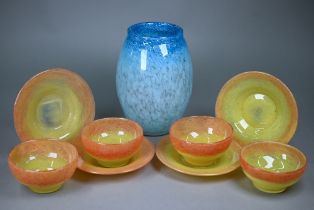 A set of four Vasart 12 cm bowls and 17cm saucers, with mottled red and yellow decoration to/w an