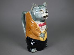 A French majolica pottery novelty water-jug, modelled as a cat night-club singer with guitar,