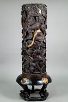 A 19th century Japanese Shibayama hardwood stick stand with brass liner, profusely carved and