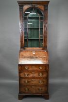 A diminutive Georgian style cross-banded walnut bureau bookcase, the arched astragal glazed