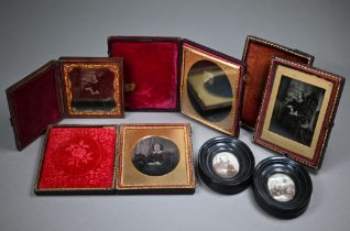 Four Ambrotype photographic portraits of ladies and a gentleman, in gilt mounts and leather pocket-