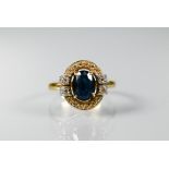 An oval sapphire and diamond cluster ring, 18ct yellow gold set, size N, approx 4.4g all in