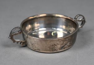 A silver tastevin with twin scroll handles, S. Blackensee & Son Ltd., Chester 1935, 2.8oz, 8.5oz