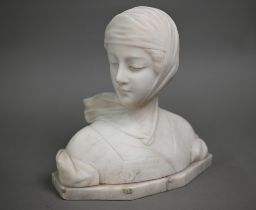 An Italianate marble bust of a young woman in a headscarf, signed indistinctly, 23 cm high (base