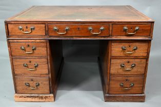 A Victorian mahogany partner's desk, the gilt tooled green leather inset top over a trio of frieze