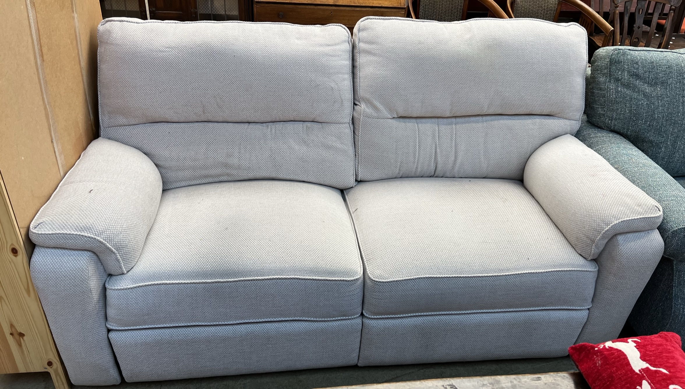 A three seater settee with recline action in cream