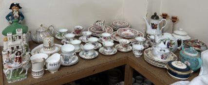 A collection of Royal Albert tea cups and saucers together with Staffordshire type cottages,