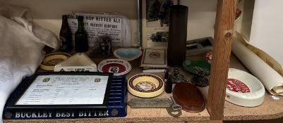 Assorted breweriana including a pump handle, ashtrays, bottles together with a shell case,