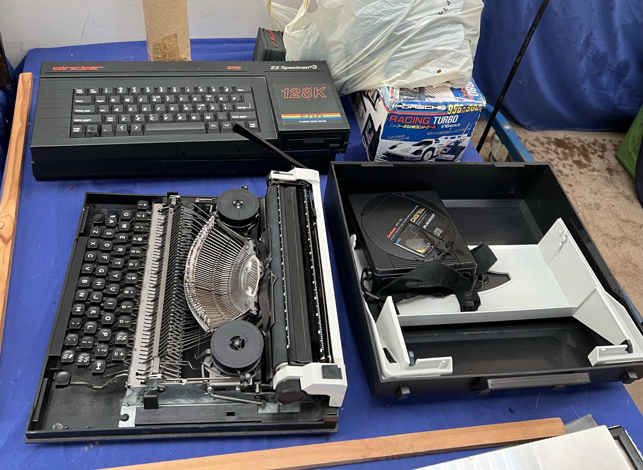 Two ZX Spectrum+3 computers (sold as seen, untested) together with a racing car,