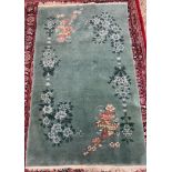 A Chinese rug, with a green ground decorated with flowers and leaves ,