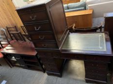 A pedestal desk with a green leather top,