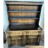 A 20th century oak dresser, with a moulded cornice above two shelves,