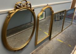 A gilt wall mirror of oval form with ribbon swag surmount together with three other wall mirrors