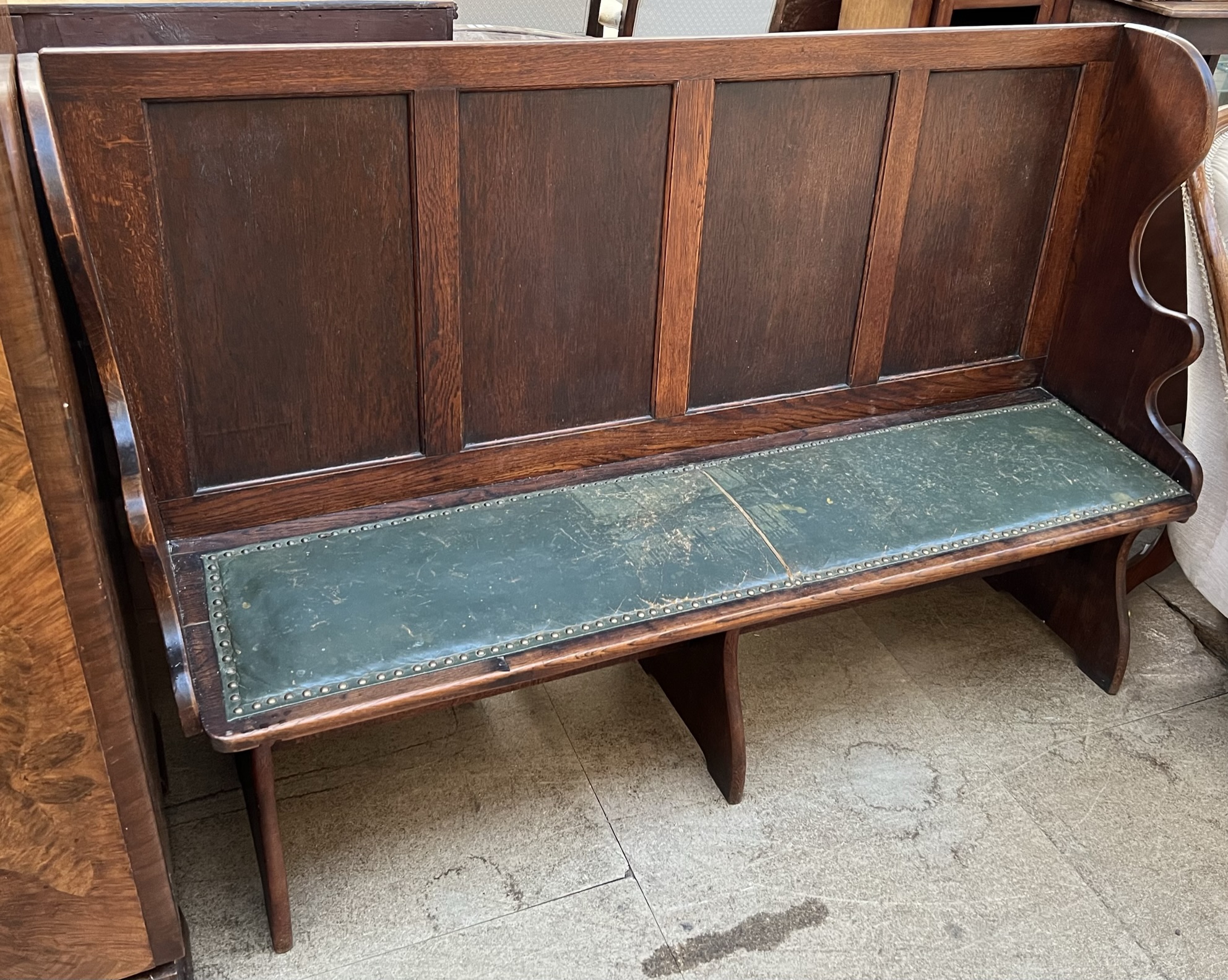 A 20th century oak bench, with a four panelled back pad seat and slab sides,