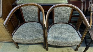 A pair of Edwardian mahogany tub chairs with upholstered back and seats on square legs and spade
