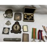 A silver cigarette case together with vesta cases, World War II Medals, buttons,