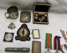 A silver cigarette case together with vesta cases, World War II Medals, buttons,