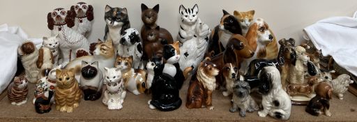 A collection of pottery cats and dogs