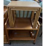 A light oak nest of three tables together with a teak tea trolley and a teak tray