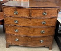 A George III mahogany chest of D shape above two short drawers and three long drawers on splayed