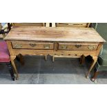 A 19th century dresser base with a rectangular top above two drawers and a shaped apron on cabriole