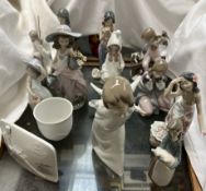 A collection of Lladro and Nao figures including Tahitian figures, angel, goose,