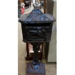 A cast iron post box with a caddy top and crown surmount on a pedestal and rectangular base,