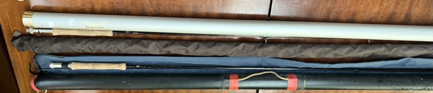 A Fenwick Iron Feather IF 999 9'9" fly fishing rod with cover and metal tube together with a