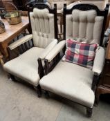 A pair of Edwardian mahogany library chairs with a carved back above a button upholstered back,