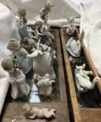 A collection of Lladro and Nao figures including an elephant, swan and cygnets, goose and goslings,