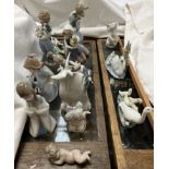 A collection of Lladro and Nao figures including an elephant, swan and cygnets, goose and goslings,
