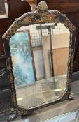 A Chinoiserie decorated easel mirror with a shell carved top and figural decoration