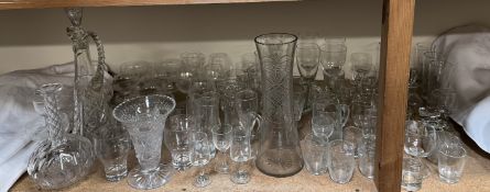 A cut glass decanter together with a large glass vase,