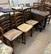 A 20th century oak gateleg dining table together with a set of seven ladder back dining chairs