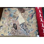 A wall hanging depicting a maiden holding a fan surrounded by birds and feathers together with a