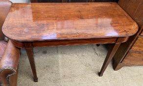 A late George III mahogany dining table end section decorated with satinwood and ebony stringing,