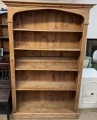 A Pine bookcase with a moulded cornice and fluted columns on a plinth base,