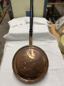A copper bedwarming pan,