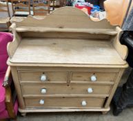 A Victorian pine wash stand / chest with a 3/4 gallery and shelf above two short and two long