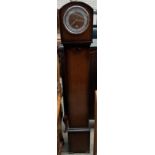 An oak cased grandmother clock, with a circular dial and Arabic numerals,