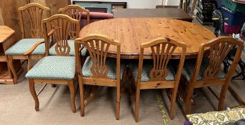 A modern pine extending dining table and six chairs