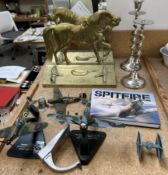 A pair of brass horse doorstops stamped "Llanelly tinplate" together with a pair of candlesticks,