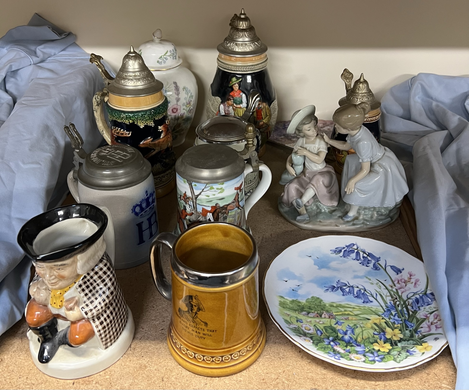 Assorted steins together with a Nao figure etc