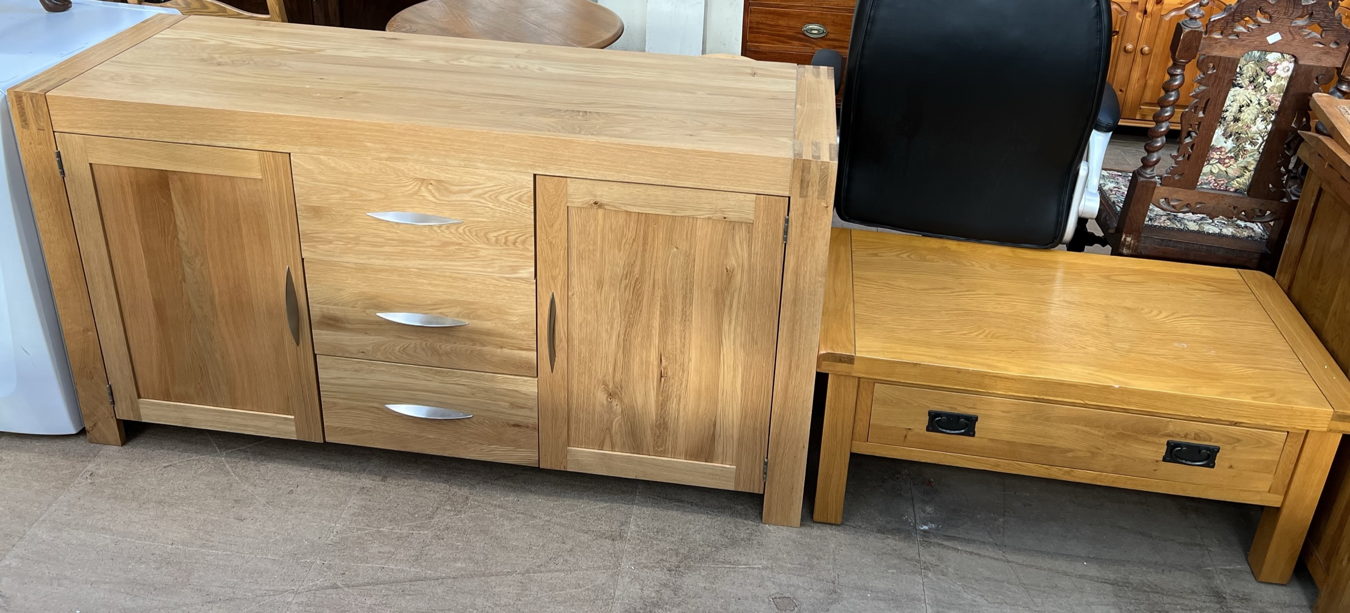 A Modern oak sideboard with two cupboards and three drawers together with a coffee table