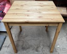 A modern pine table of square form on square legs