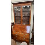 A George III and later mahogany bureau bookcase with an associated top,